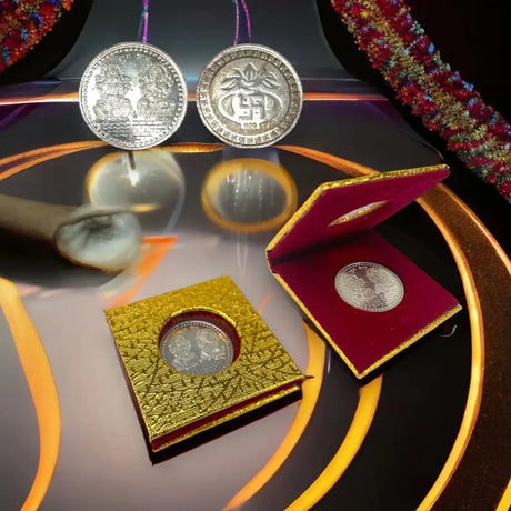 Indian return gifts: gold-colored commemorative coin in decorative box symbolizing cherished tradition deeply rooted