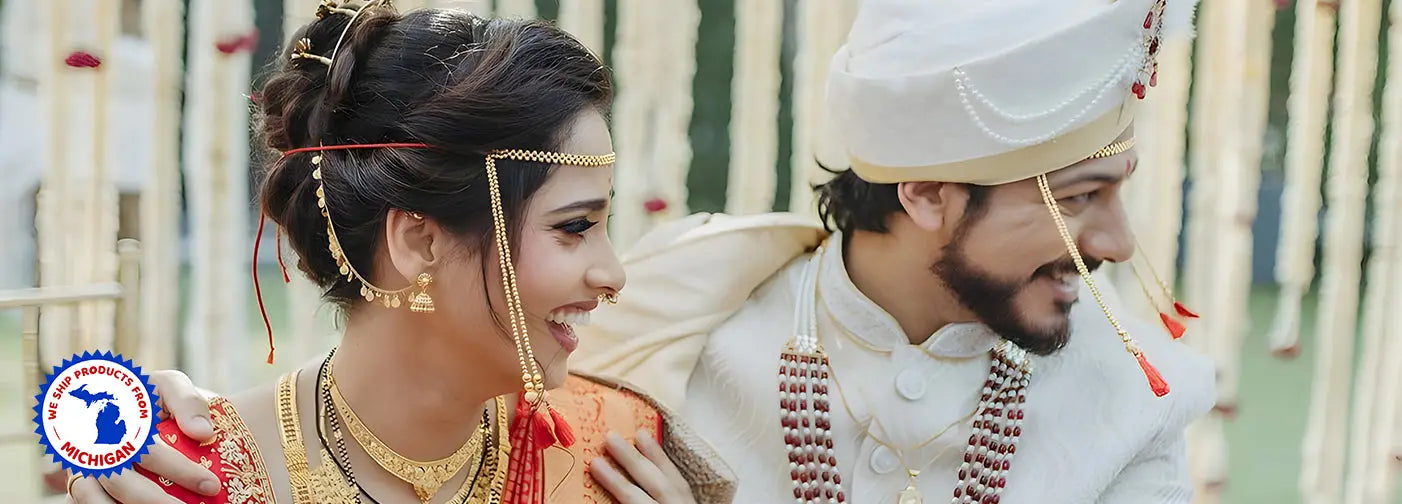 Bride and groom in traditional Indian wedding attire celebrating with unique Indian wedding favors in USA.