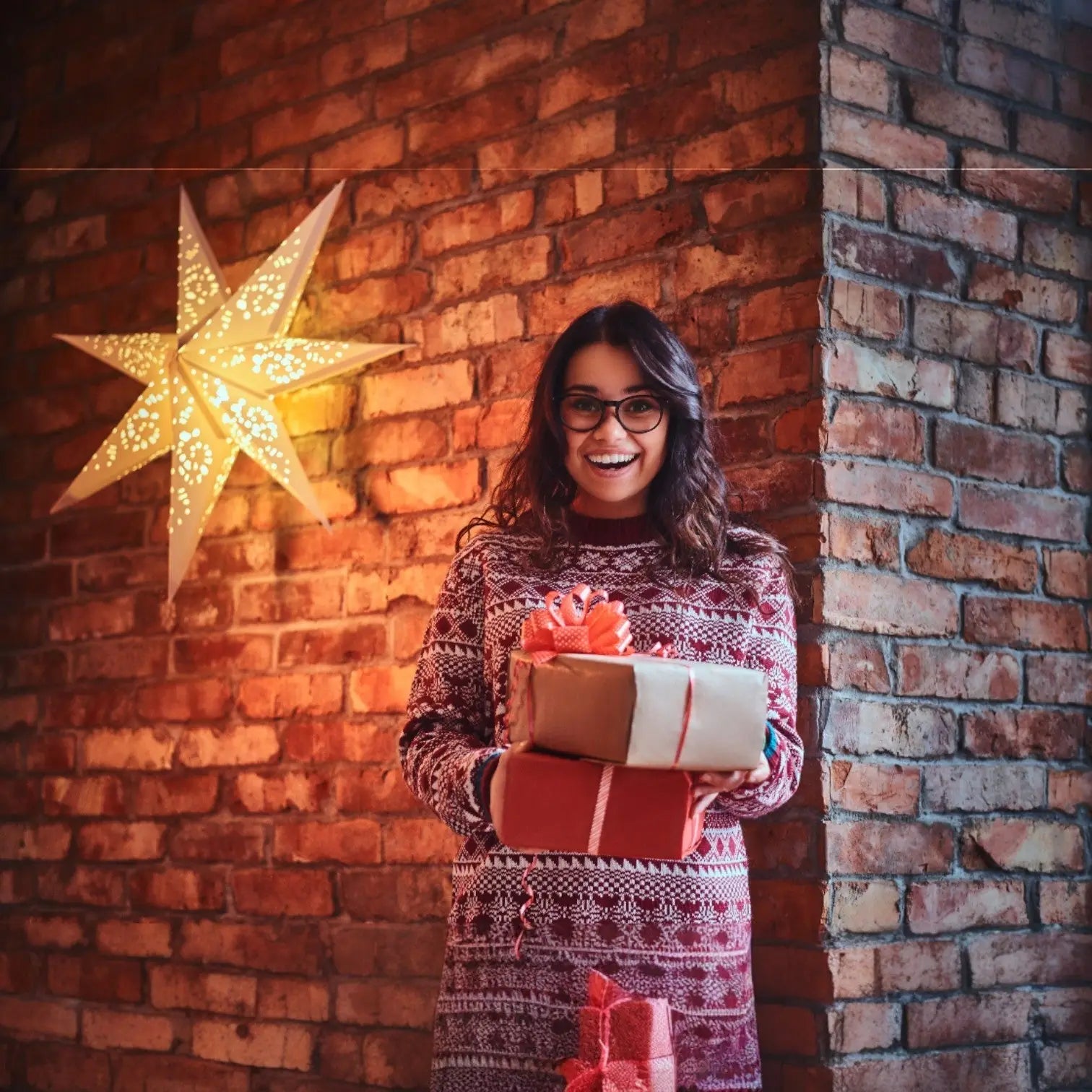 Girl holding diwali gifts in diwali in office with lantern decor