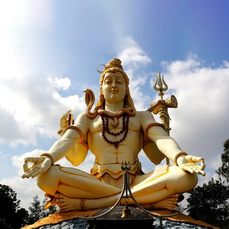 Statue of Lord Shiva in meditative pose holding symbolic objects for celebrating Shivratri
