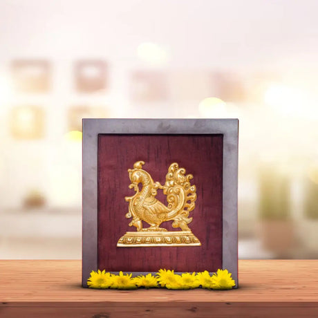 Golden peacock figurine with ornate tail displayed in a framed setting for Indian wall decor
