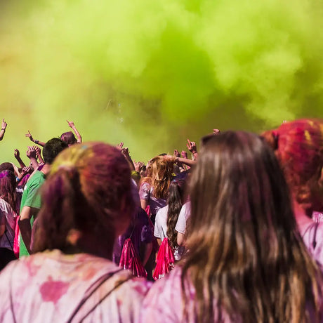 Crowd celebrating Holi with vibrant festival colors and organic Holi colors display