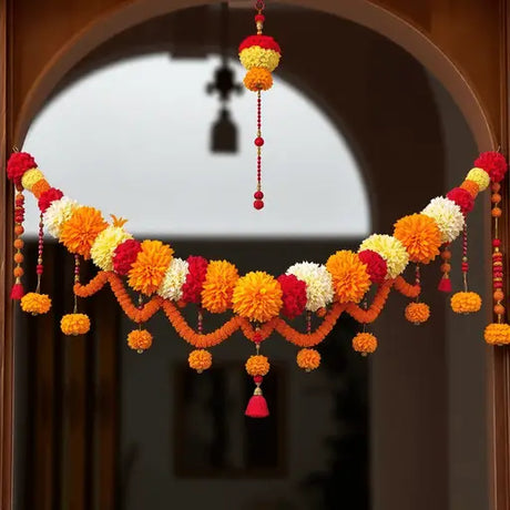 A colorful traditional Indian toran with marigold and jasmine flowers and beads hanging across a doorway.