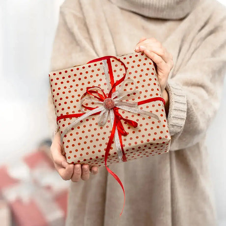 Gift wrapped in polka dot paper with a red ribbon bow for an unforgettable Eid celebration