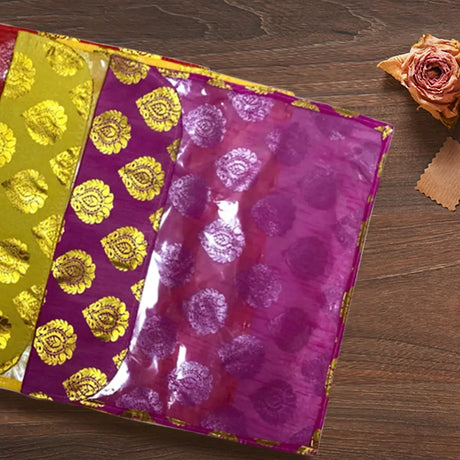 Colorful floral gift wrapping papers on wooden surface for wedding return gifts and decorative diyas