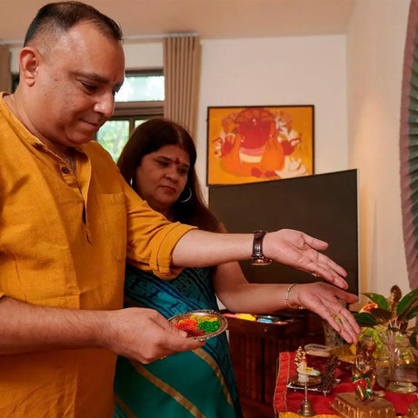 A man and woman stand beside a table filled with various dishes, engaging in conversation and enjoying the meal.