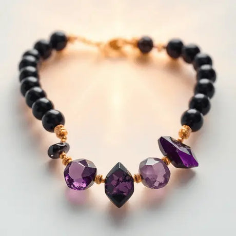 Close-up of a stylish bracelet with black tourmaline and amethyst crystals against a soft, glowing background symbolizing positive energy and balance.