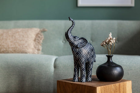 Cozy living room with elegant elephant sculptures and key holders, blending traditional and modern styles with warm, inviting lighting.
