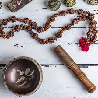 Close-up of textured Rudraksha beads in a prayer mala with natural brown tones on a soft, warm background evoking spirituality and tranquility.