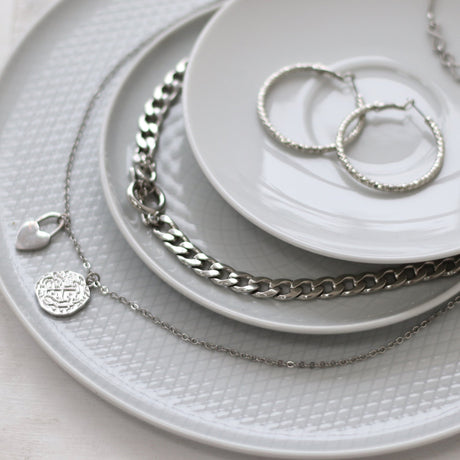 Sterling Silver is a pure silver alloy that contains 92.5% pure silver, unlike German Silver, also known as Nickel Silver, which is an alloy of nickel, copper, and zinc yet achieves a similar silver look and appearance.