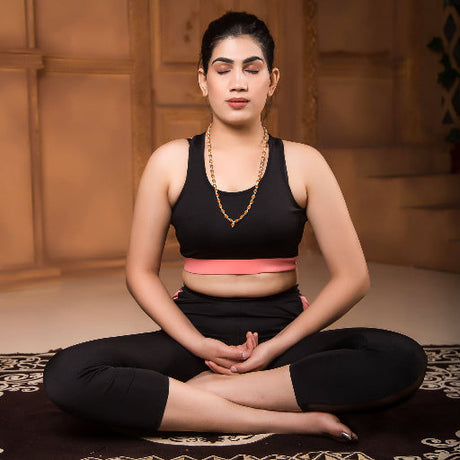 Meditating woman in yoga pose wearing Certified Rudraksha Mala for prayer and meditation