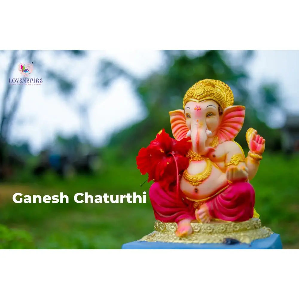 Colorful statue of the Hindu deity Ganesha with an elephant head, seated and adorned in traditional attire