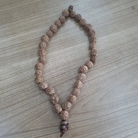 Close-up of natural rudraksha beads arranged in a traditional mala that looks appealing with its mesmerizing impact.