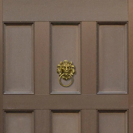 Ornate golden lion door knocker on brown door highlighting timeless appeal of brass door knockers