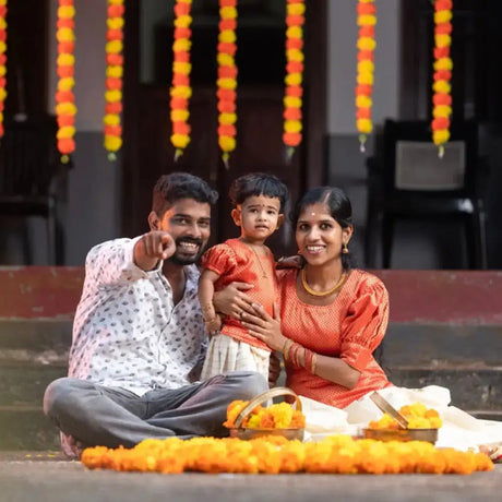 Family of three smiling together during Tamil Pongal decor celebration in USA - LoveSnspire