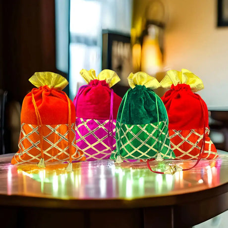Four illuminated bags arranged on a table, creating a visually striking and festive atmosphere.