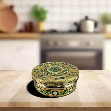 Ornate circular tin showcasing intricate green and gold floral patterns for roti box essentials
