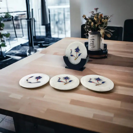 White marble coasters with blue floral inlay designs for seasonal Indian décor and home décor