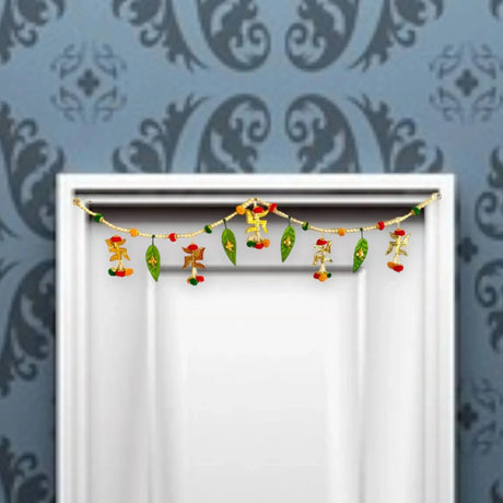 A decorative golden door bandhanwar with swastika and mango leaves design featuring colorful hanging beads