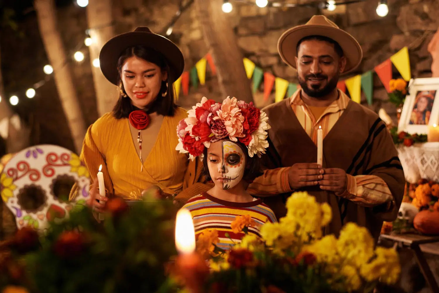 A family wearing colorful traditional Mexican costumes, smiling and posing together in a festive setting.