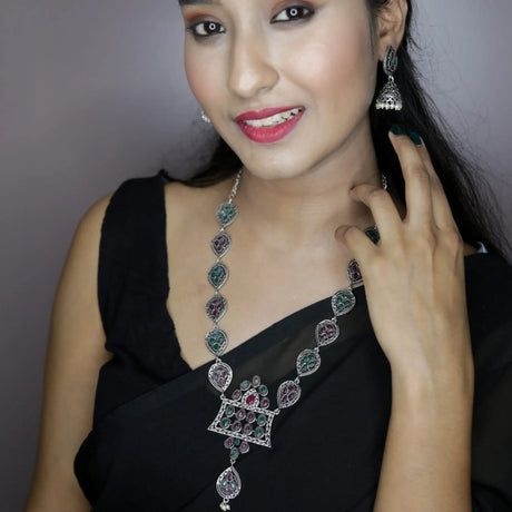 Silver-toned long necklace with colorful stones and matching jhumka earrings in minimalist Indian jewelry style