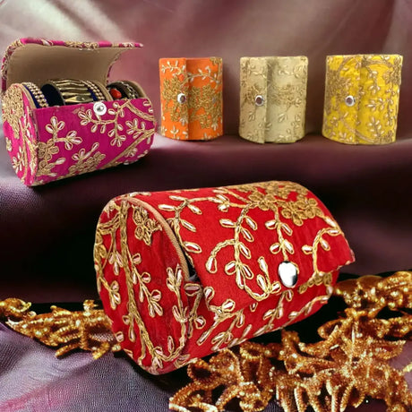 Ornate Indian bracelet boxes with floral embroidery on red fabric showcasing intricate designs