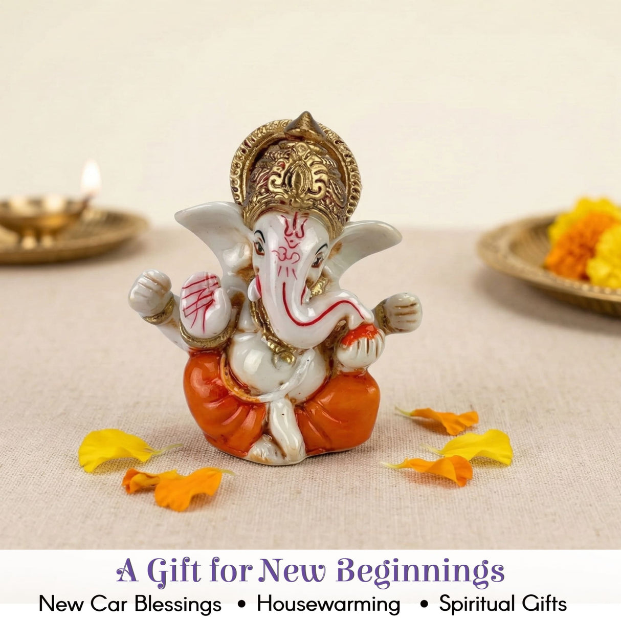 White orange ceramic Ganesha statue with gold accents for car dashboard