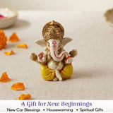 A small 1 ct acrylic ganesha statue figurine with white body golden crown yellow dhoti for car dashboard and home decor