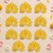 Yellow lotus flower rangoli cutouts with gold-trimmed edges for reusable home decor during indian festivals and weddings
