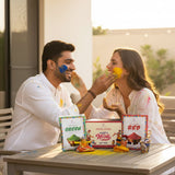 Handmade Holi gift box with green red yellow gulal, pichkari, keychains