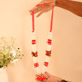 Red white floral idol mala garland with rose accents, held by hands