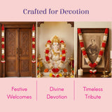 White Ganesha statue with gold details and red-white satin garland