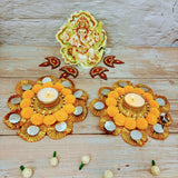 Golden decorative candle holders with yellow pompoms and mirrors for Diwali and festive decor