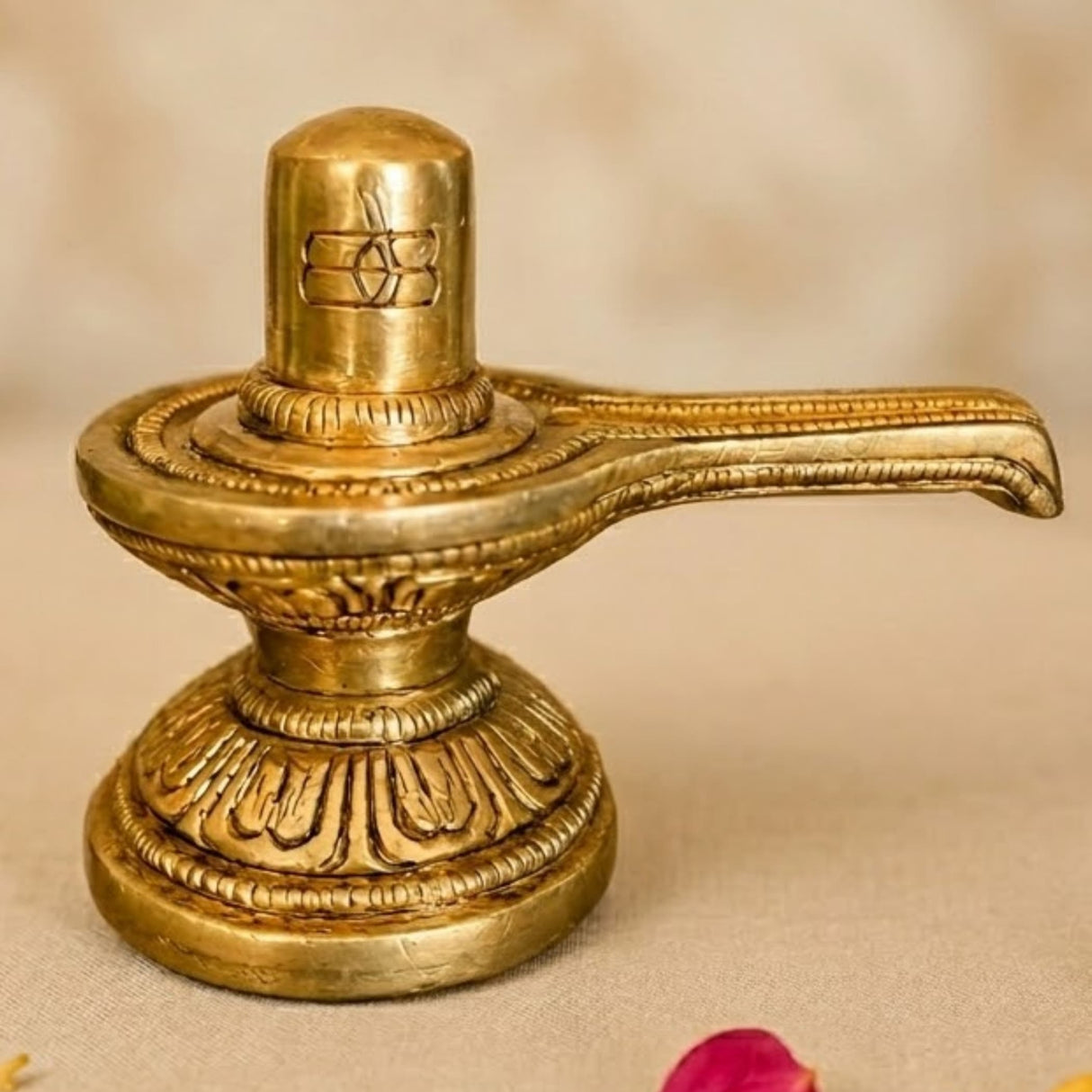 Golden brass shiva lingam statue with intricate engravings and decorative base for hindu pooja and home temple decor