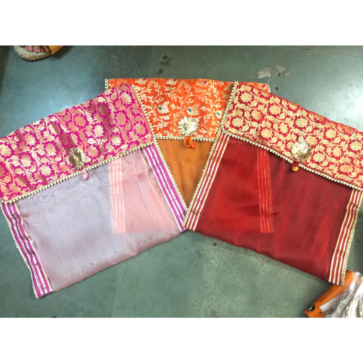 Pink and orange floral brocade fabric with gold trim saree covers for wardrobe storage