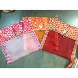 Pink and orange floral brocade fabric with gold trim saree covers for wardrobe storage