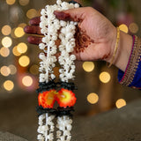2 strings artificial jasmine buds garland with delicate white plastic flowers black accents and orange yellow centers for festivals