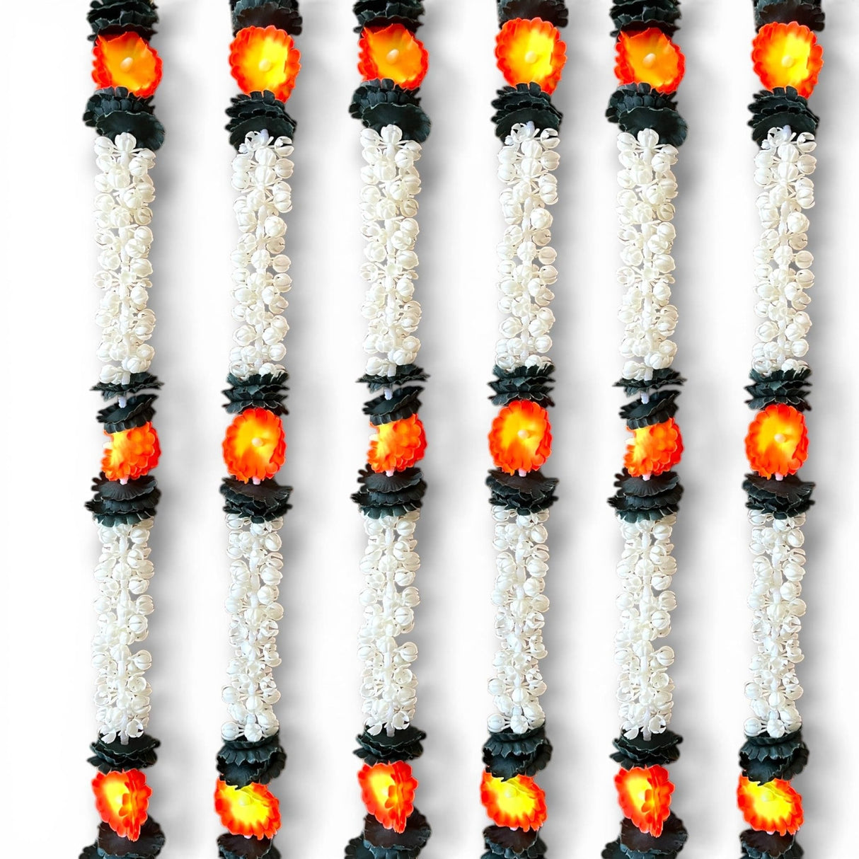 Two strings artificial jasmine buds garland with white and black floral design and glowing orange center flowers for festive decoration