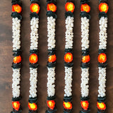 White and black artificial jasmine buds garland with glowing orange accents for festivals pooja and wedding decor