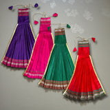 Four vibrant pleated Gudi Vastra dresses in purple, pink, green, red with gold tassels