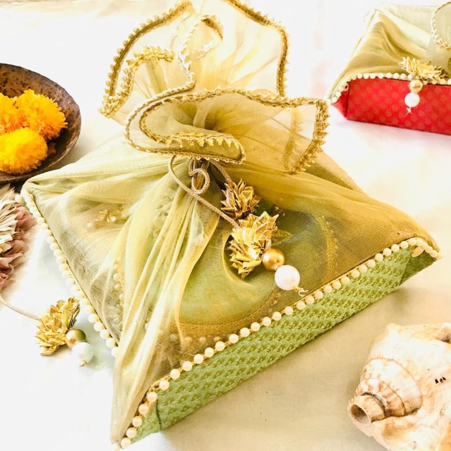 Green and gold decorative box with pearl trim seashell accents and ribbon bow for Shagun gifts
