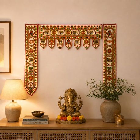 Golden ganesha statue with intricate detailing seated on a decorative base with marigold flowers for home decor