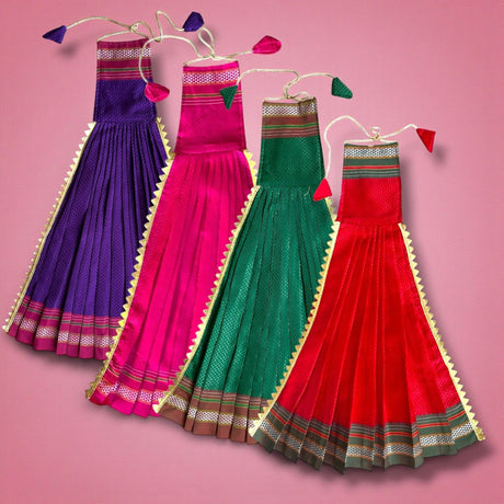 Four vibrant pleated Gudi Vastra skirts in purple, pink, green, red with gold trim