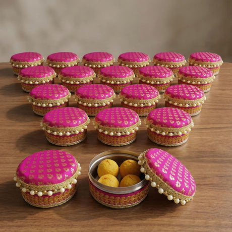 Vibrant pink fabric covered 4 ct steel ladoo box with gold embroidery and pearl trim for Holi Diwali gifting