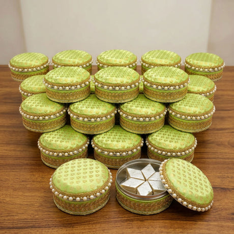 Lime green and gold embroidered stainless steel ladoo boxes with pearl trim perfect for holi diwali sweets gifting