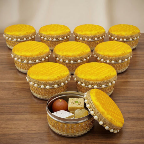 Yellow fabric-lidded 4 ct steel ladoo box with gold-embossed metal body and pearl trim for festive sweets gift use