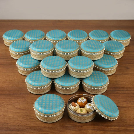 Turquoise-blue patterned steel ladoo boxes with gold trim and pearl embellishments for festival sweets gift purposes