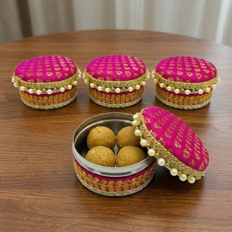 Four count steel laddu boxes in pink and gold embroidered fabric with pearl trim perfect for festive sweets gifts