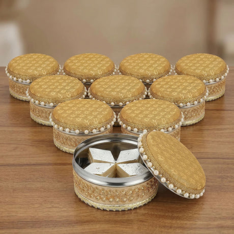 Golden fabric-lined 4 ct steel ladoo box with pearl trim and hinged lid containing sugar cubes for festive gifting