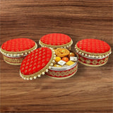 Decorative red and gold velvet-style boxes with pearl accents for festival sweets
